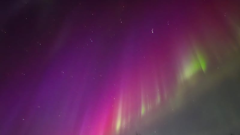 A pink and purple aurora shines above Meadow Lakes around midnight on New Year's Day.