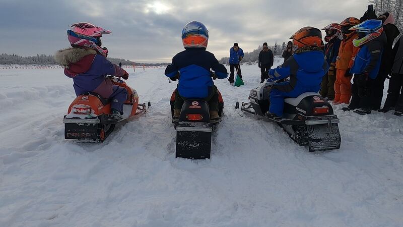 Members of the Iron Dog board made a racetrack and gathered youth snowmachines for kids to get...