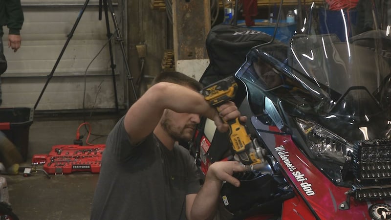 Racers get a chance to work on their machines during the Iron Dog's wrench day.