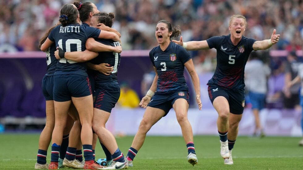 Alev Kelter (far right) and the United States women's rugby team celebrate after winning the...