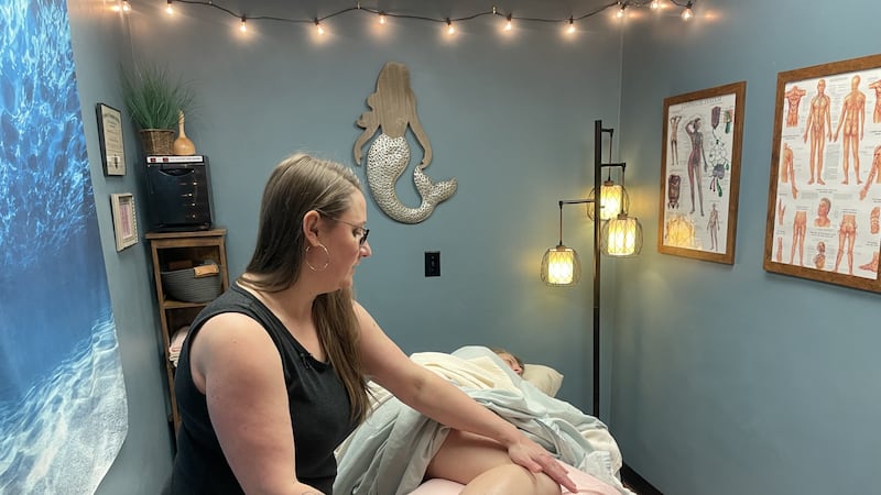 Jamie Newsom Eaton doing lymphatic drainage treatment on a pregnant client.