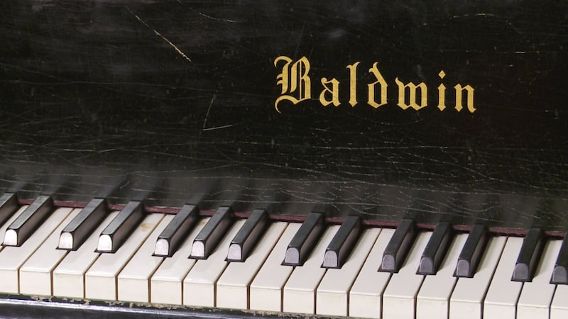 With a worn exterior and cracked soundboard, this 9 foot Baldwin D concert grand piano has...