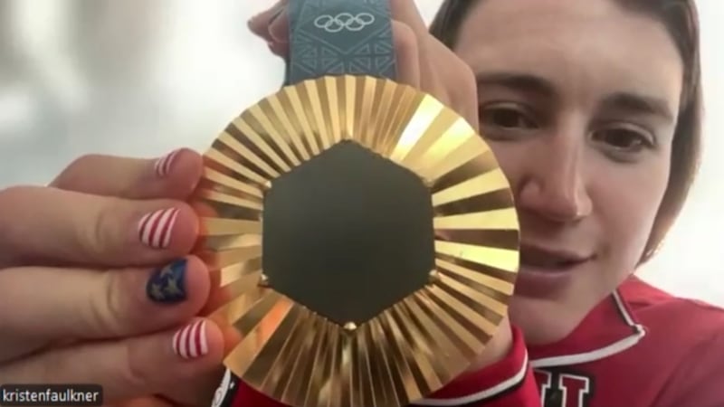 Kristen Faulkner of Homer shows off her Olympic gold medal from the women's road cycling race...