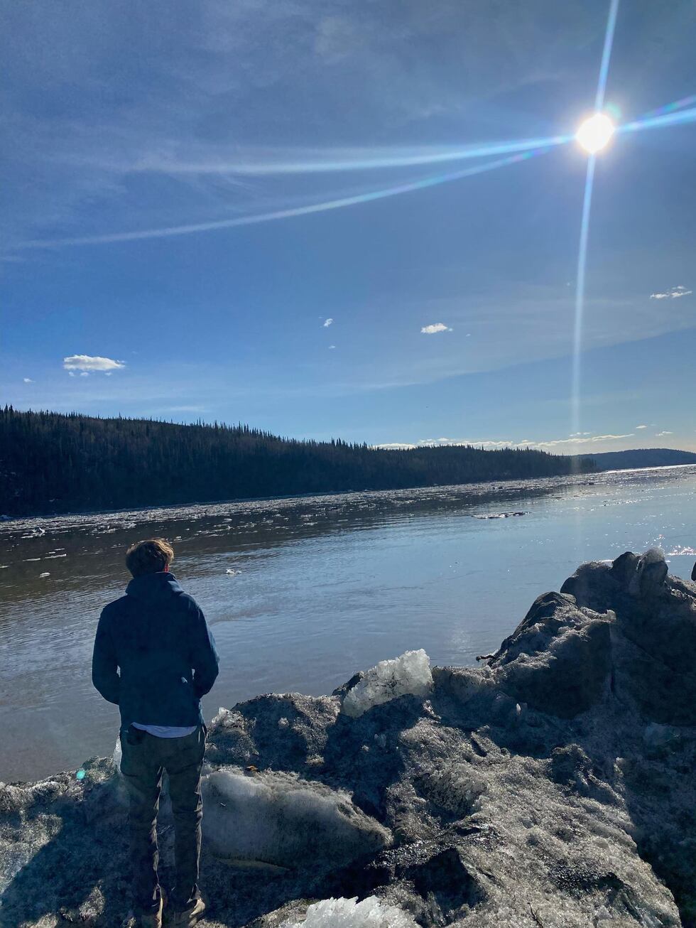 Jordan Rodenberger stands along the ice banks of the Yukon River in May.