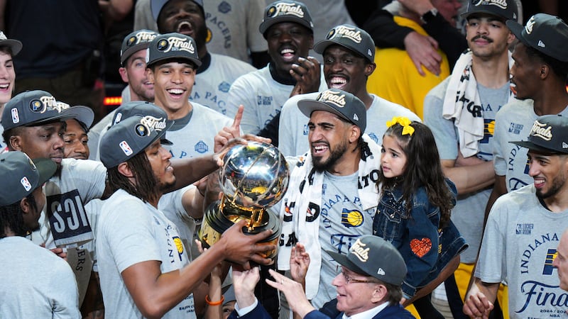 Indiana Pacers players celebrate with the trophy after winning Game 6 of the Eastern...