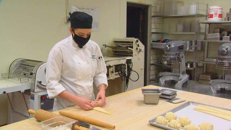 Bakery and pastry arts student, Rebecca Branin, prepares ham and cheese croissants in the...