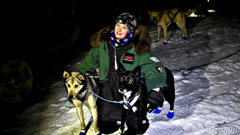 17-year old Emily Robinson, of Nenana, poses with her lead dogs after winning the  Knik 200...