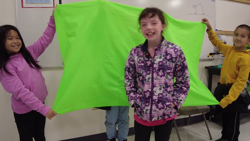Susitna Elementary students learn how to present the weather on a green screen.