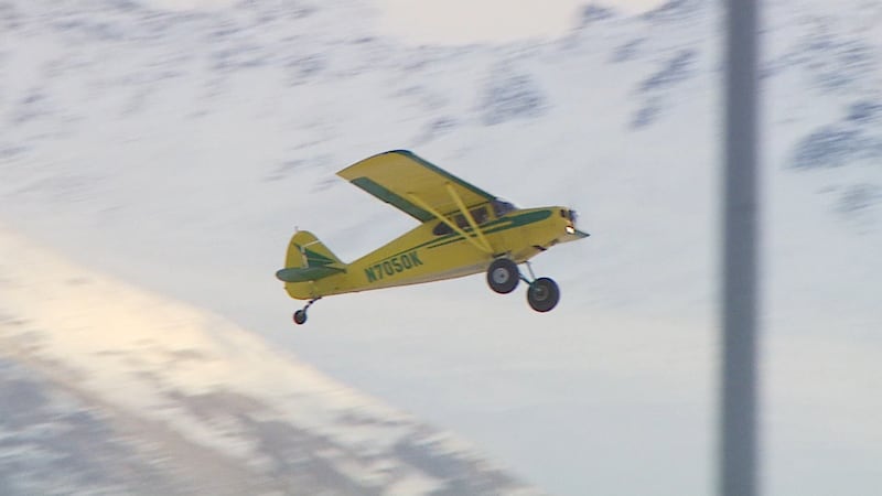 A single prop airplane flying in Alaska.