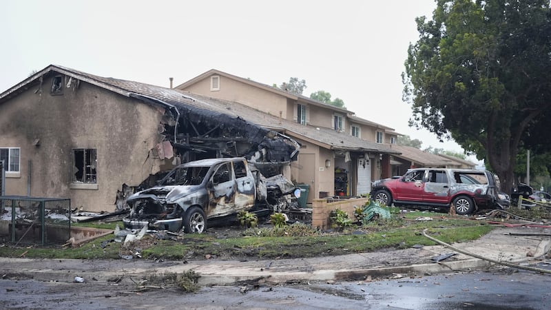 Vehicles and houses are damages after a small plane crashed into a San Diego neighborhood,...