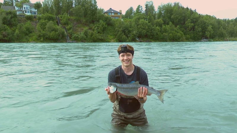Jordan Rodenberger poses with a sockeye salmon caught on the Kenai River.