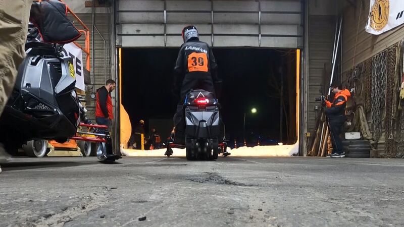 Brett Lapham, of Team 39, exits the Nome garage and heads southbound with the remaining Iron...